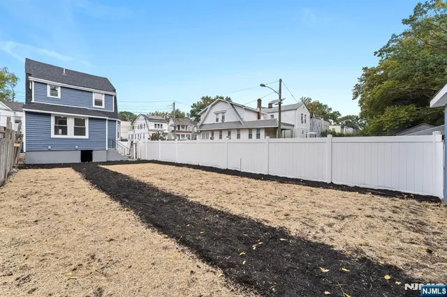 a view of a backyard with a tree