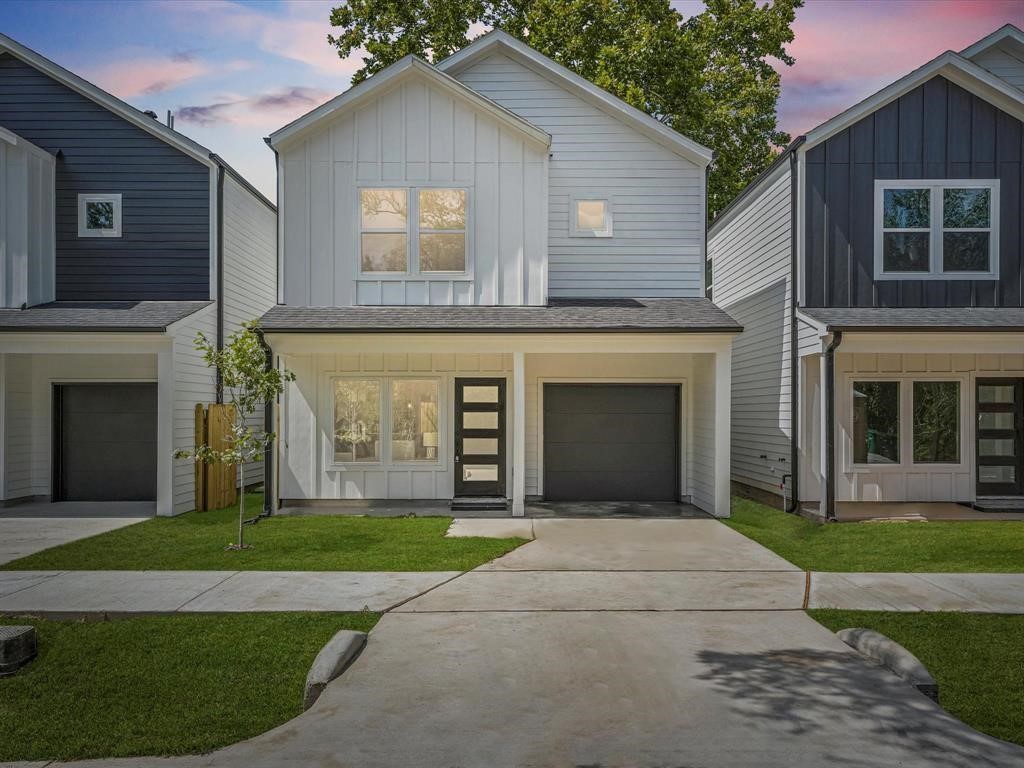 1448 Dewalt Street Houston, TX 77088 - Photo 1 of 24 a front view of a house with a yard and garage