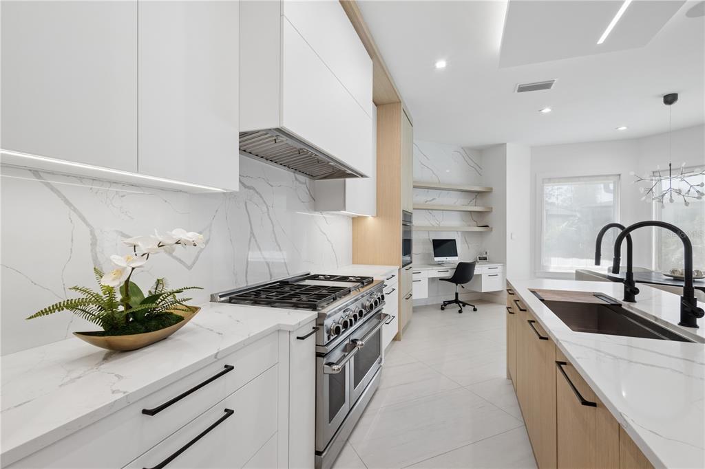 1808 Flower Drive Sarasota, FL 34239 - Photo 11 of 56 a kitchen with stainless steel appliances a sink a stove and cabinets