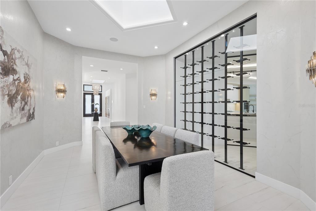 1808 Flower Drive Sarasota, FL 34239 - Photo 18 of 56 a hallway with a table and chairs