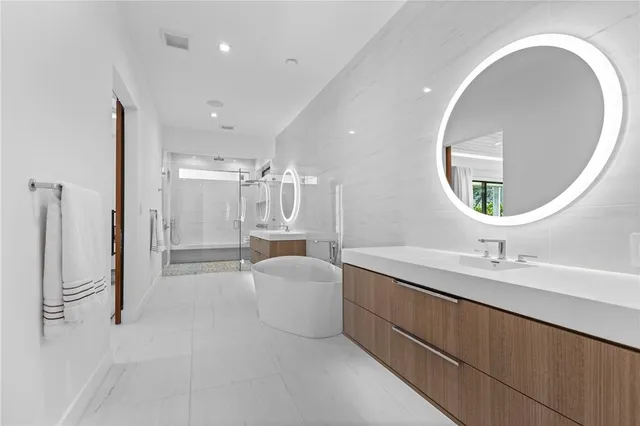 a bathroom with a double vanity sink a mirror and a shower