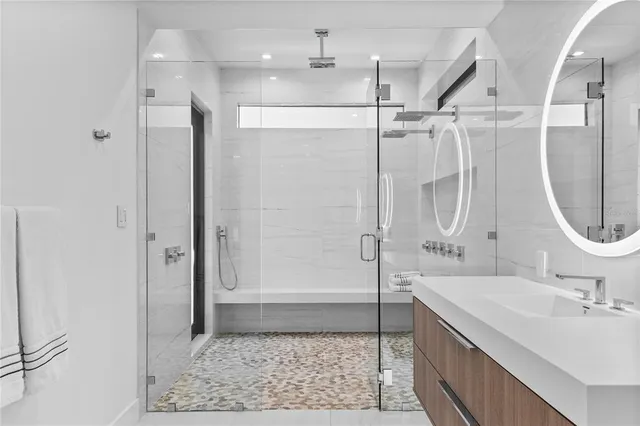 a spacious bathroom with a double vanity sink and a mirror