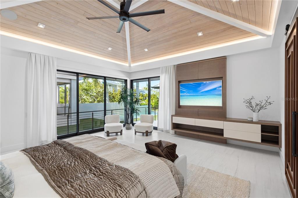 1808 Flower Drive Sarasota, FL 34239 - Photo 22 of 56 a bedroom with a large bed and a chandelier