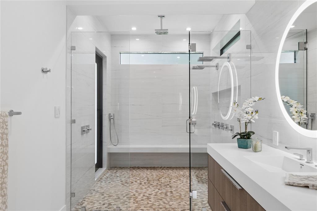 1808 Flower Drive Sarasota, FL 34239 - Photo 27 of 56 a bathroom with a shower sink and mirror