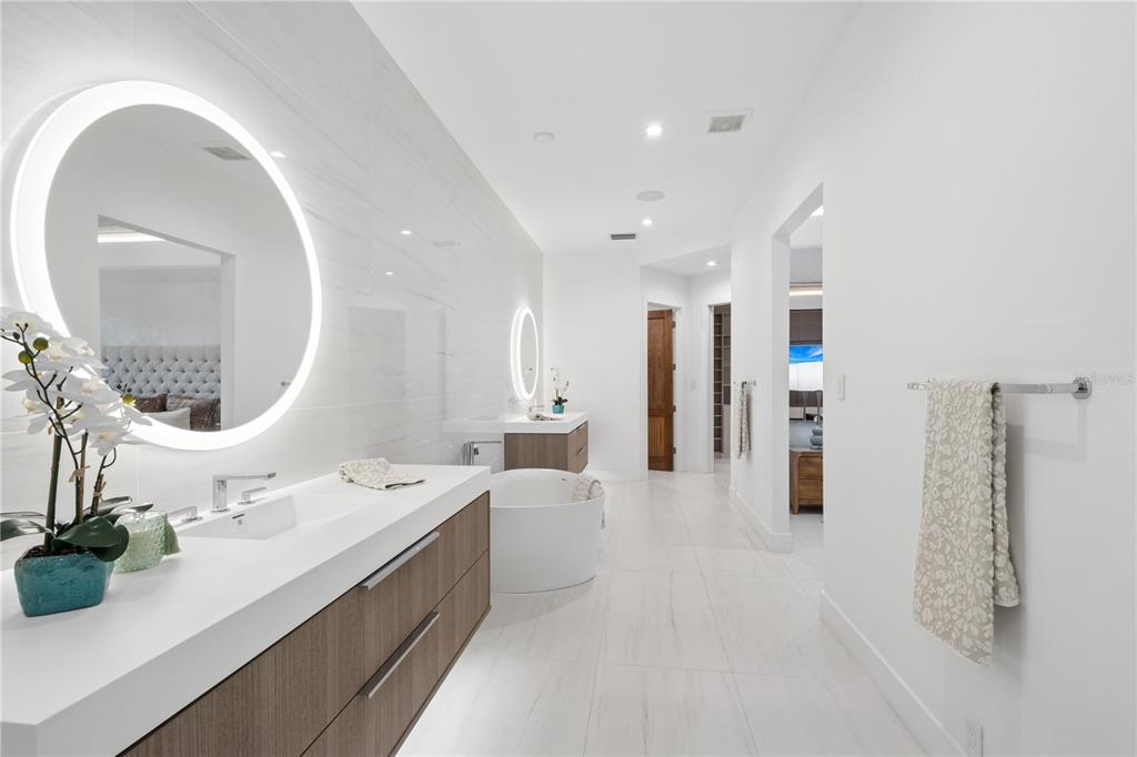 1808 Flower Drive Sarasota, FL 34239 - Photo 28 of 56 a large bathroom with a double vanity sink and a mirror