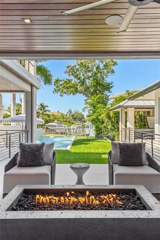a living room filled with lots of furniture and a porch