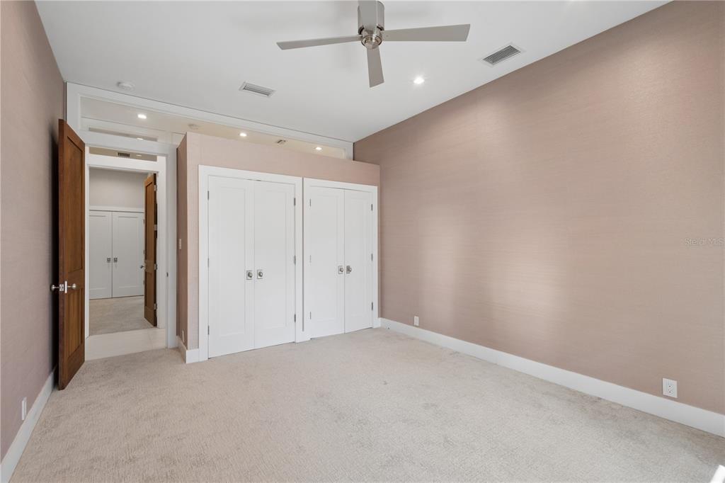 1808 Flower Drive Sarasota, FL 34239 - Photo 31 of 56 an empty room with a ceiling fan and closet area