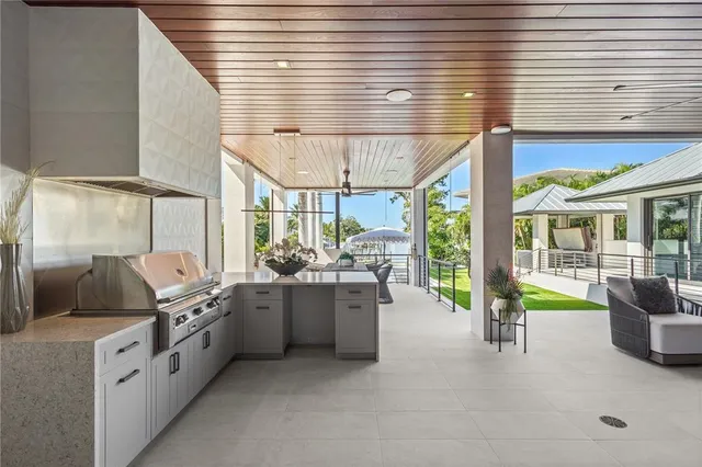 a view of a patio with chairs and a backyard