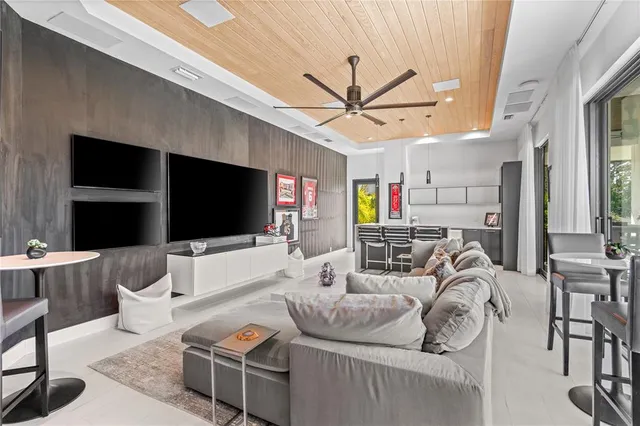a dining room with furniture and a floor to ceiling window