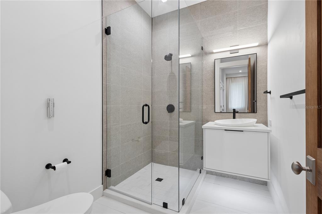 1808 Flower Drive Sarasota, FL 34239 - Photo 36 of 56 a bathroom with a sink a toilet and shower