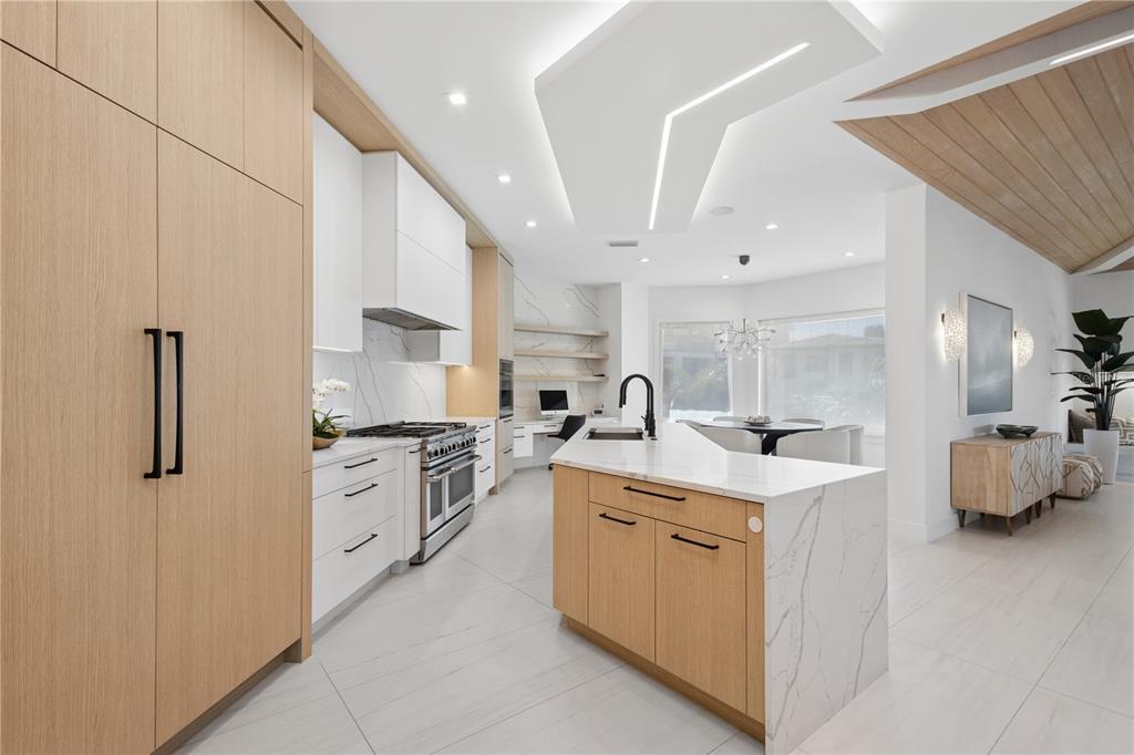 1808 Flower Drive Sarasota, FL 34239 - Photo 4 of 56 a kitchen with stainless steel appliances kitchen island a sink stove and refrigerator