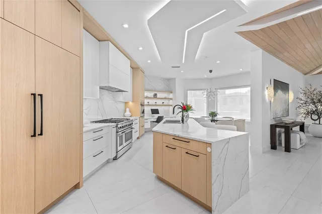 a kitchen with white cabinets appliances and sink