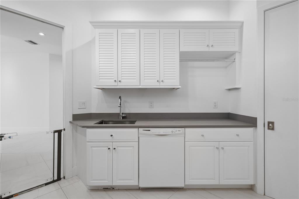1808 Flower Drive Sarasota, FL 34239 - Photo 42 of 56 a kitchen with granite countertop white cabinets and sink