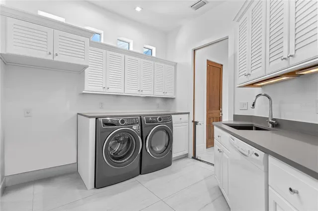 an aerial view of residential houses with outdoor space and lake view