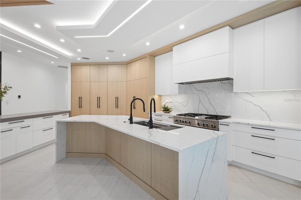 1808 Flower Drive Sarasota, FL 34239 - Photo 5 of 56 a kitchen with granite countertop white cabinets and white appliances