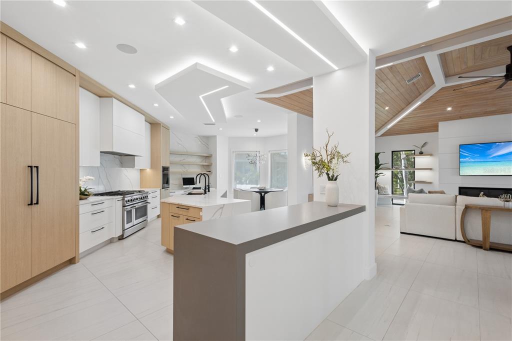 1808 Flower Drive Sarasota, FL 34239 - Photo 10 of 56 a kitchen with stainless steel appliances kitchen island a sink stove and refrigerator