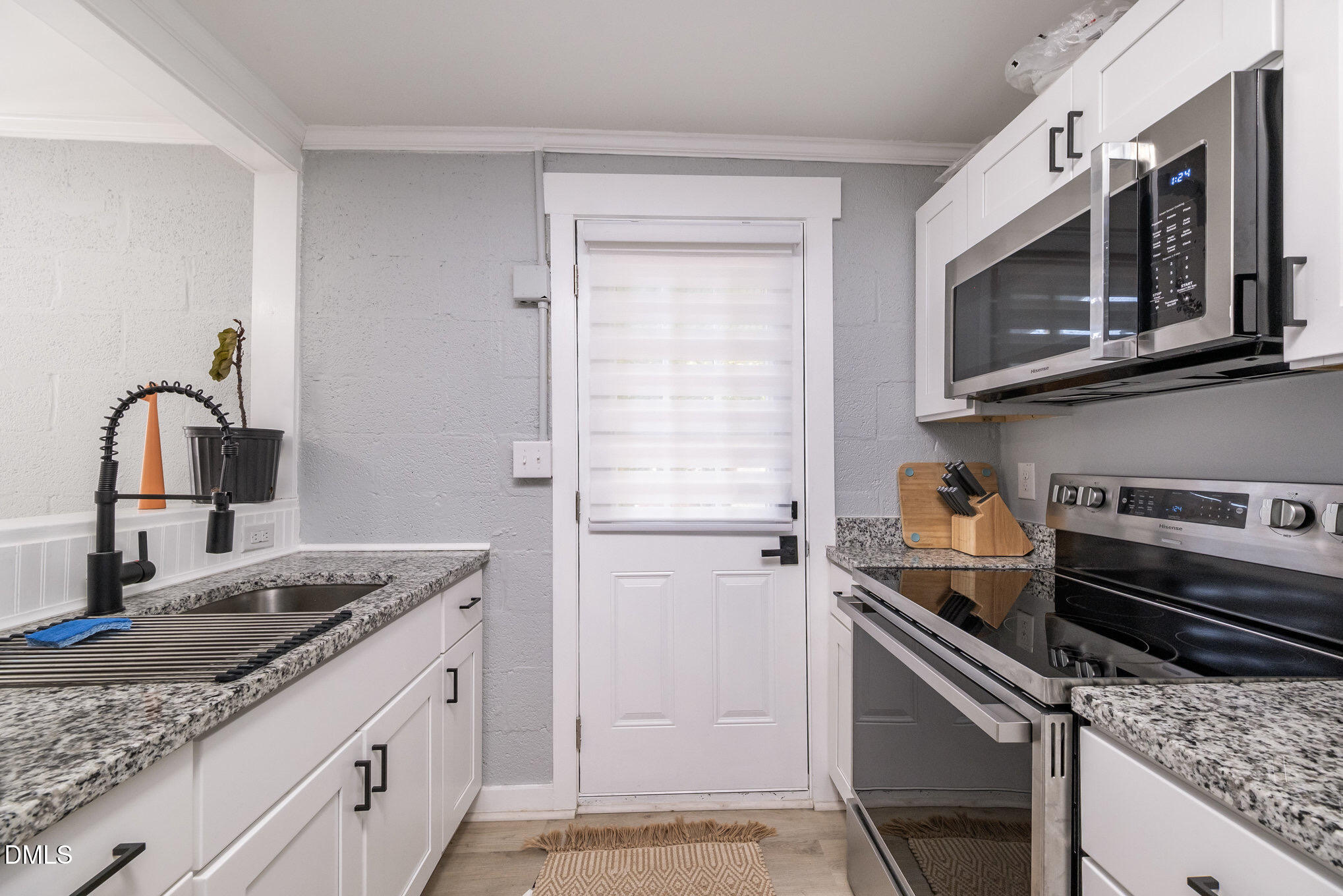 740 Quarry Street Raleigh, NC 27601 - Photo 11 of 29 a kitchen with a sink stove and microwave