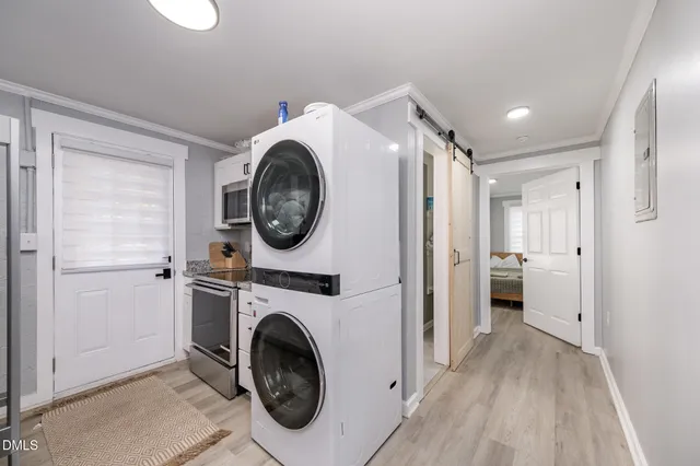 a view of a hallway with washer and dryer