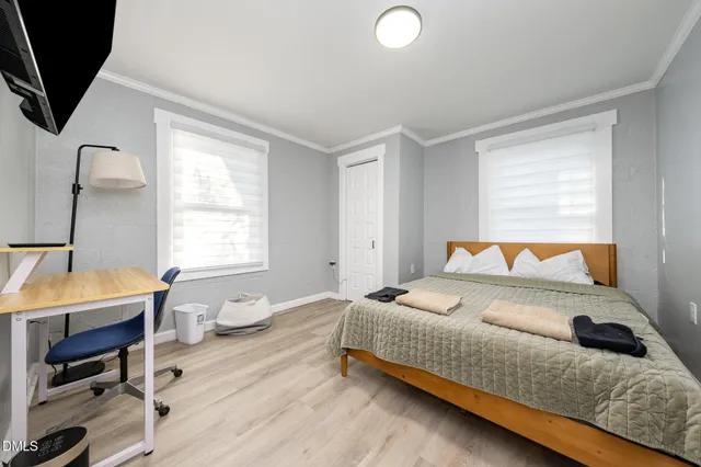 a bedroom with a bed and a window