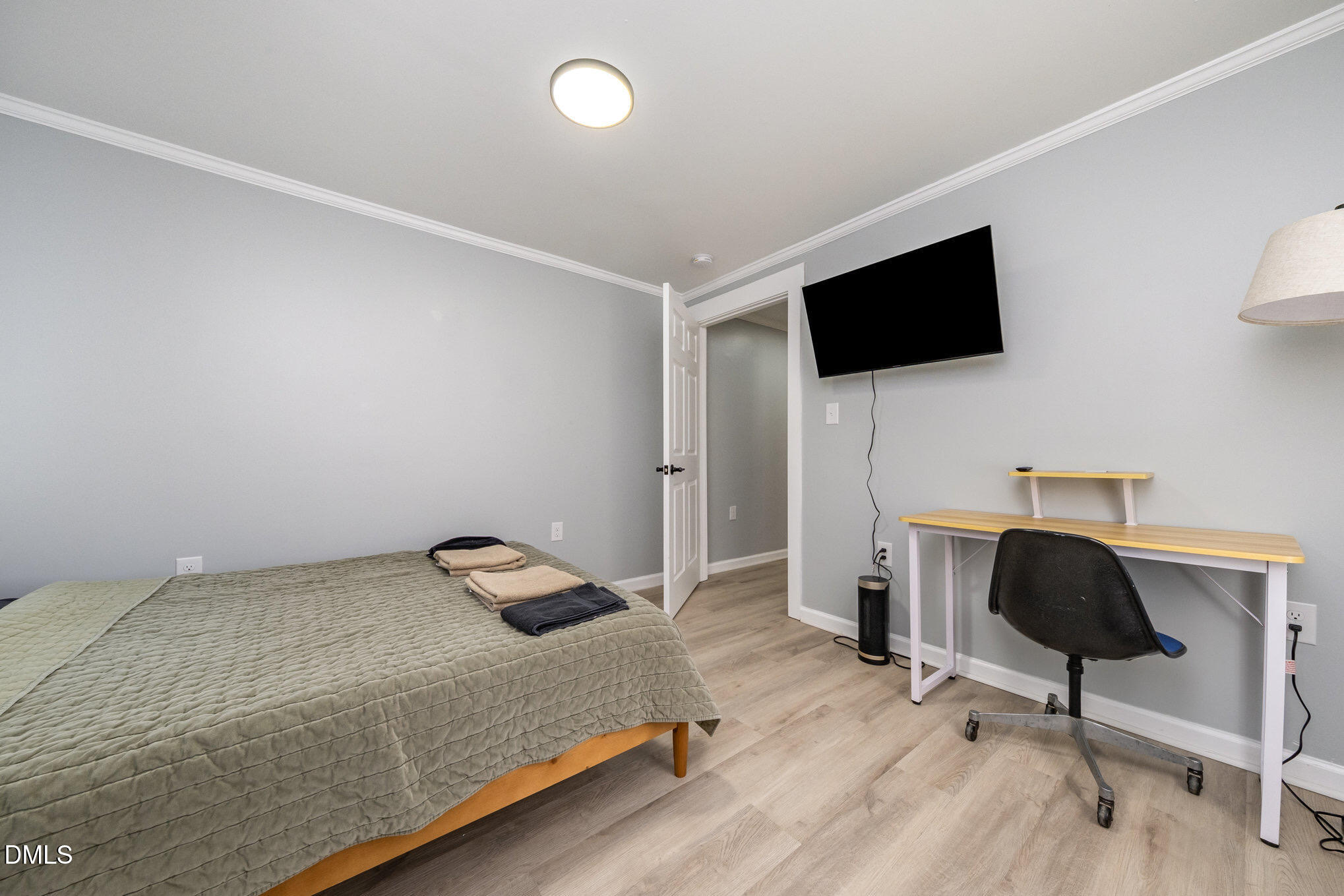 740 Quarry Street Raleigh, NC 27601 - Photo 15 of 29 a bedroom with a bed and a flat screen tv