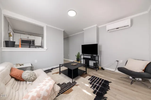 a bedroom with furniture and a flat screen tv