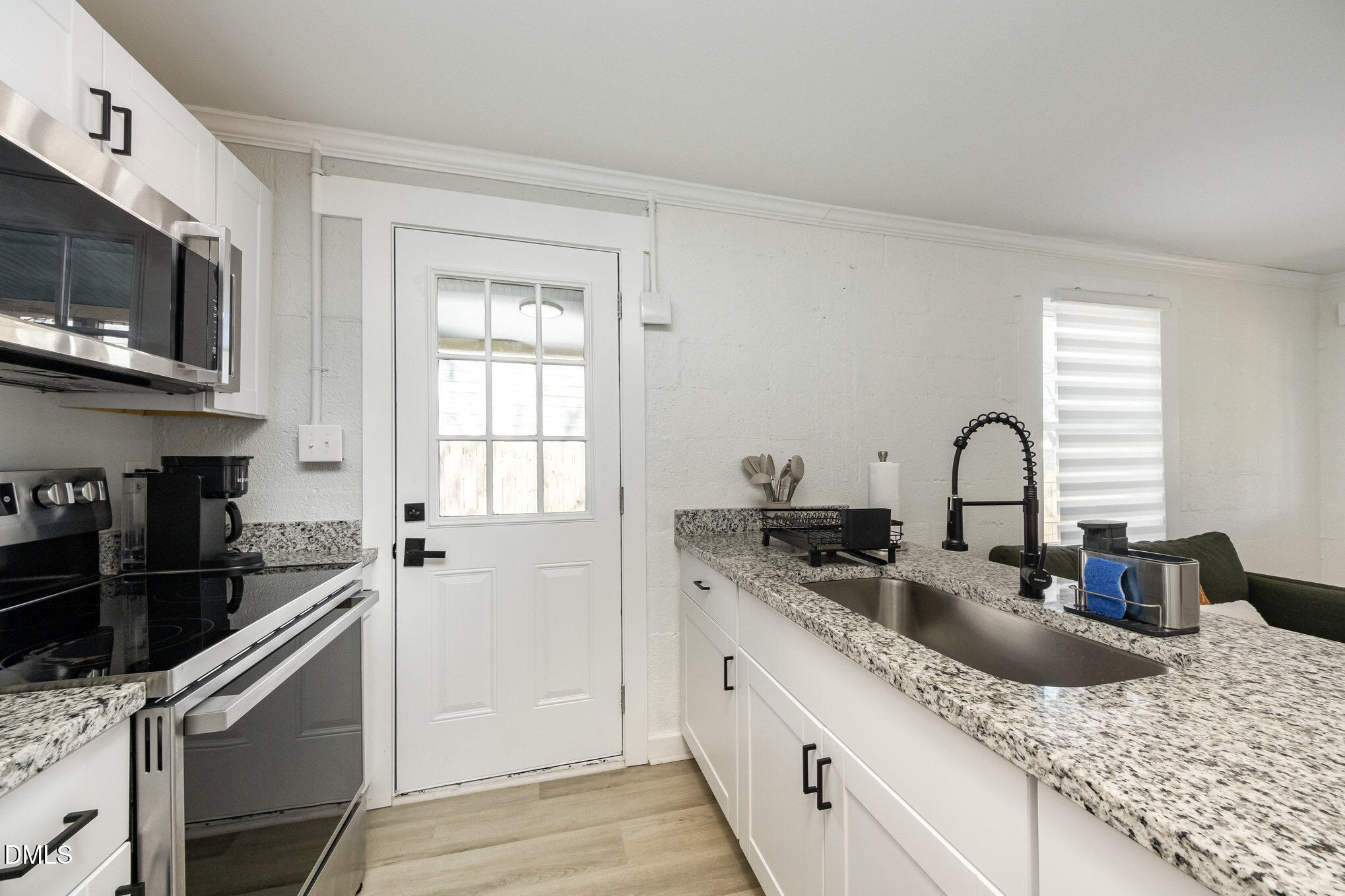 740 Quarry Street Raleigh, NC 27601 - Photo 19 of 29 a kitchen with stainless steel appliances granite countertop a sink and a microwave