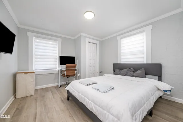 a bedroom with a bed and a flat screen tv