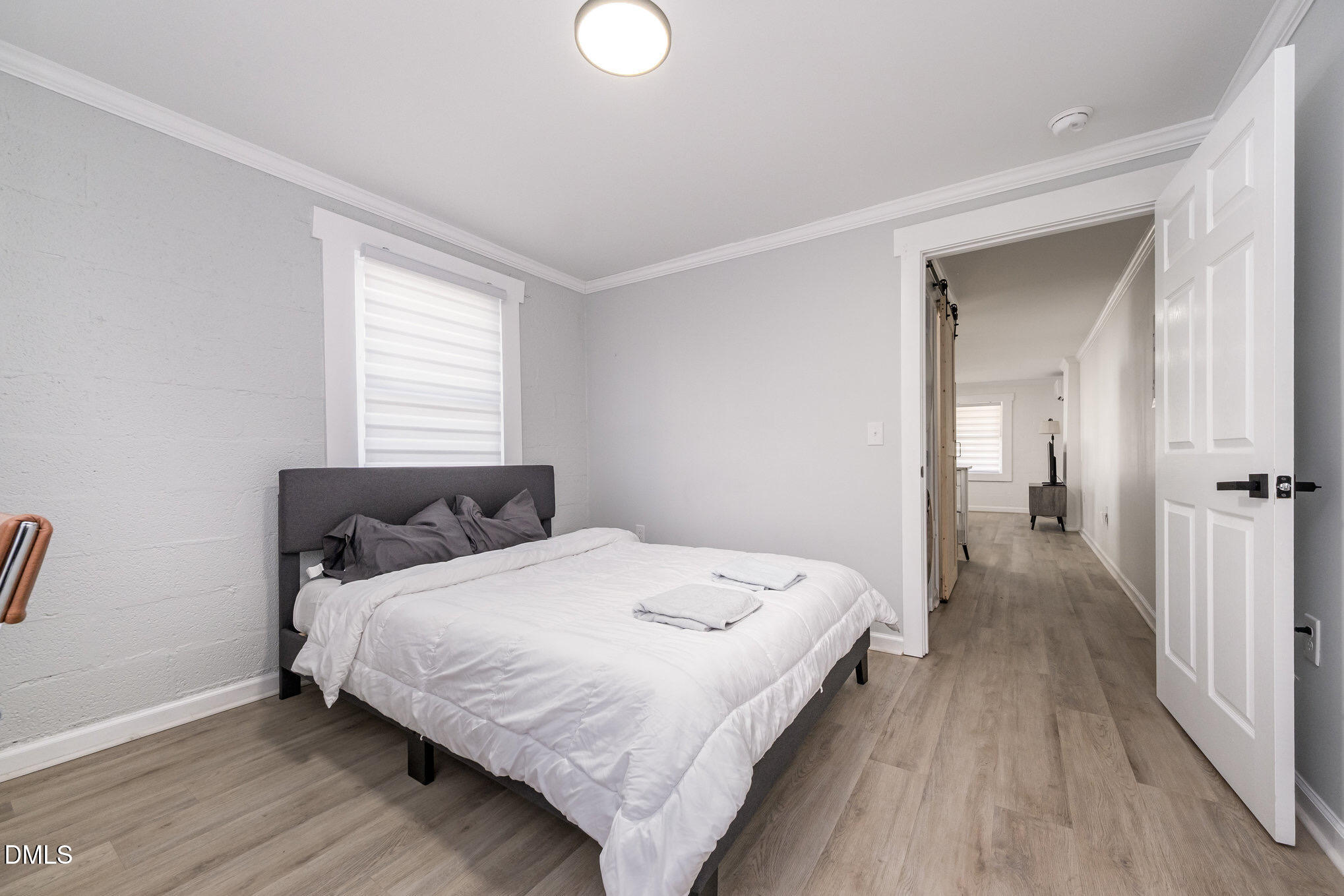 740 Quarry Street Raleigh, NC 27601 - Photo 22 of 29 a bedroom with a bed and wooden floor