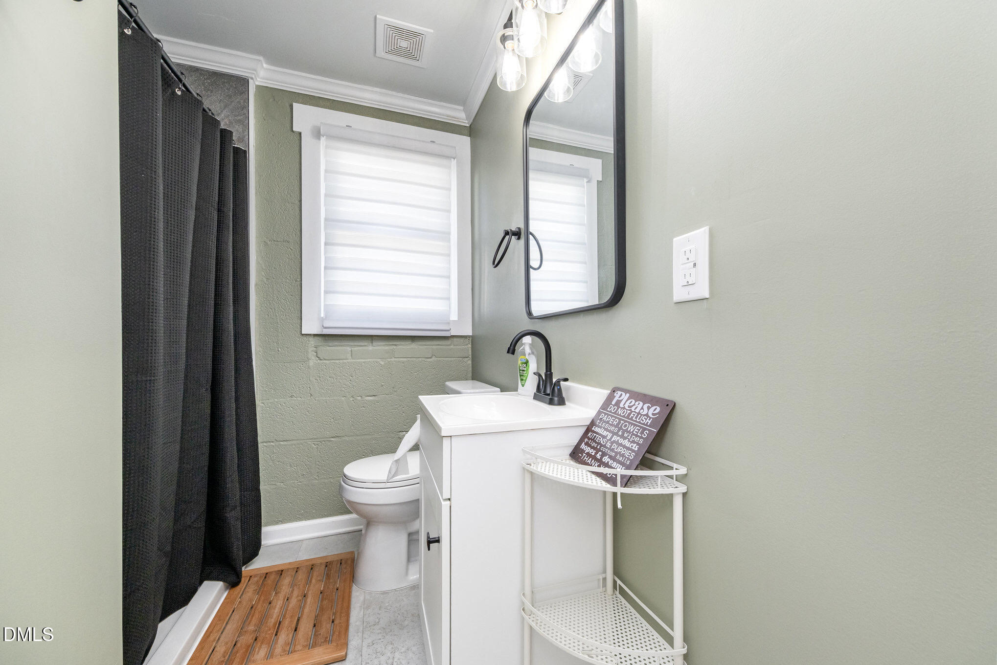 740 Quarry Street Raleigh, NC 27601 - Photo 23 of 29 a bathroom with a toilet sink and mirror