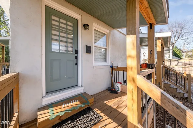 a view of a balcony with wooden floor and furniture