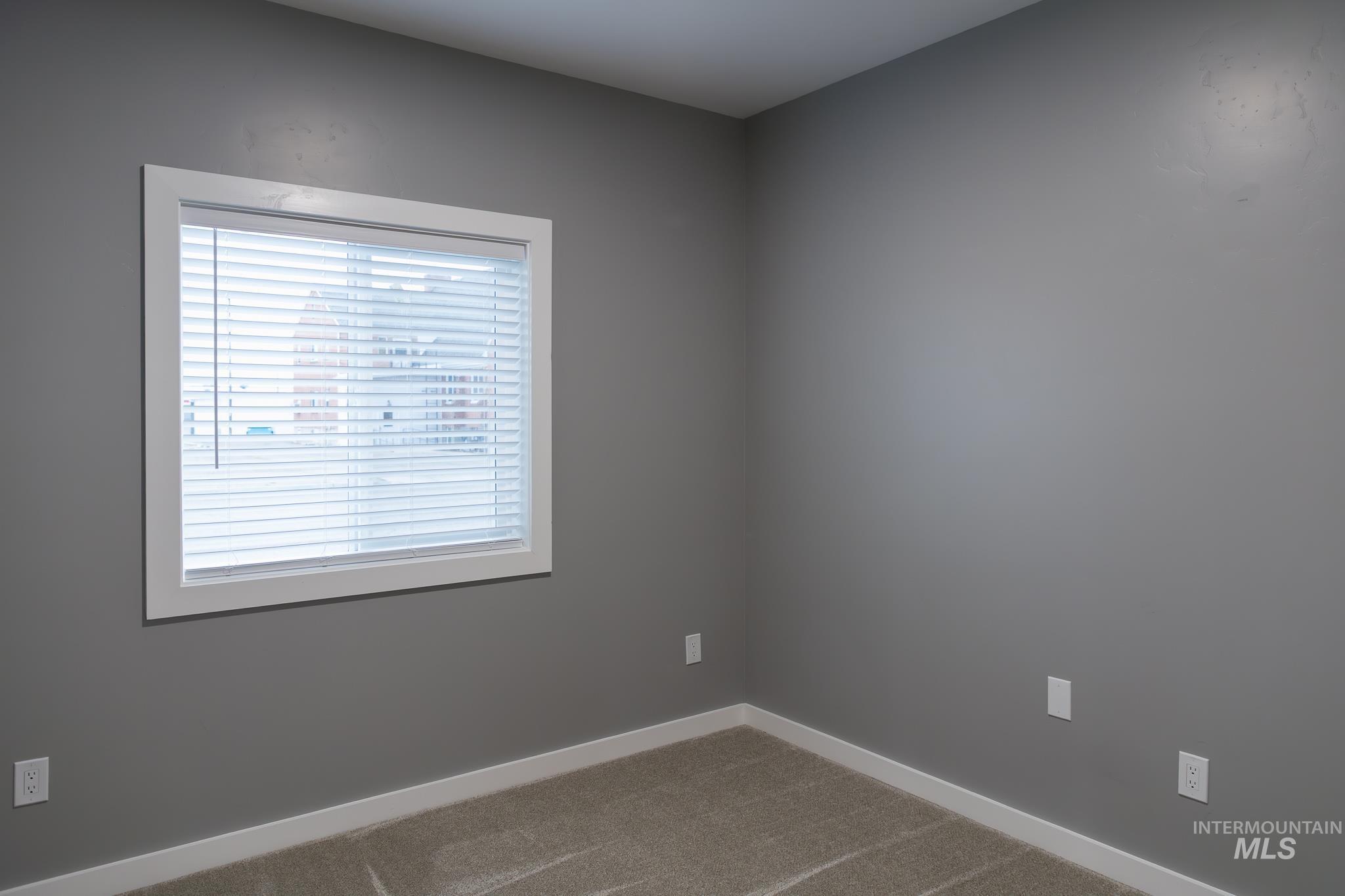 297 Southwest 6th Street, Unit 2 Ontario, OR 97914 - Photo 14 of 37 Spare room with baseboards and carpet floors