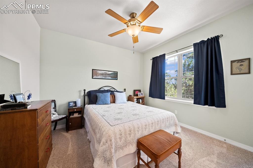 20765 Warriors Path Drive Peyton, CO 80831 - Photo 14 of 50 a bed room with a bed window and a desk