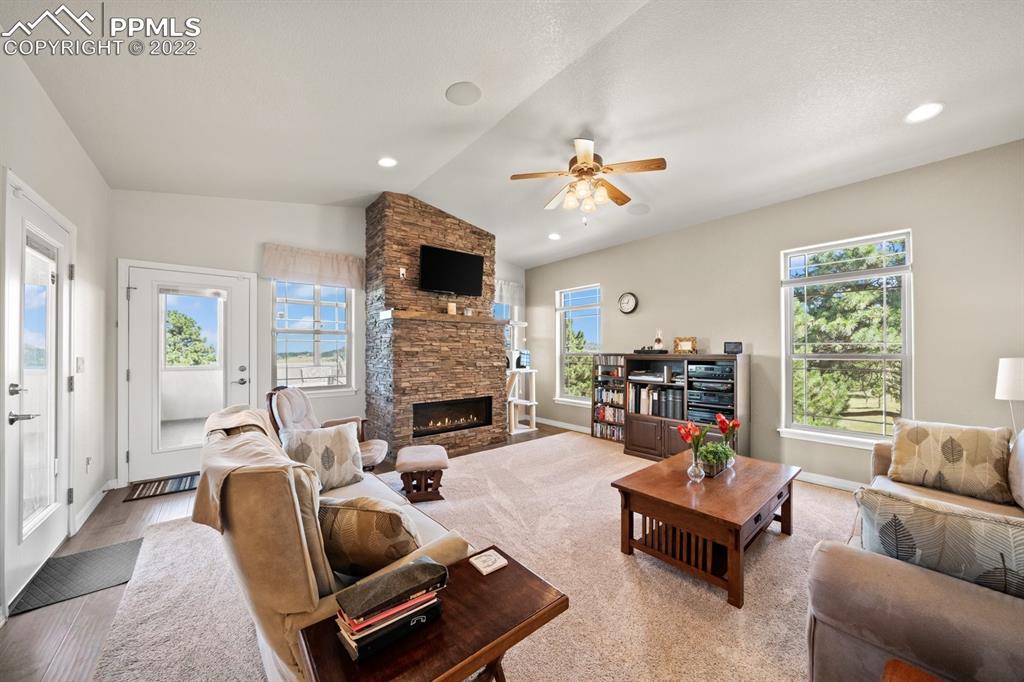 20765 Warriors Path Drive Peyton, CO 80831 - Photo 18 of 50 a living room with furniture fireplace and a large window