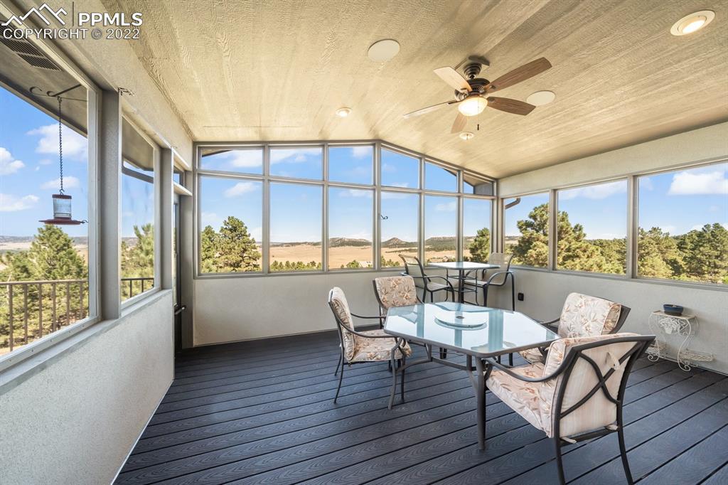 20765 Warriors Path Drive Peyton, CO 80831 - Photo 21 of 50 a dining room with furniture a window and wooden floor