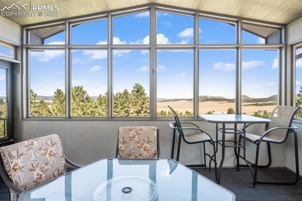 20765 Warriors Path Drive Peyton, CO 80831 - Photo 22 of 50 a view of a dining room with furniture window and outside view