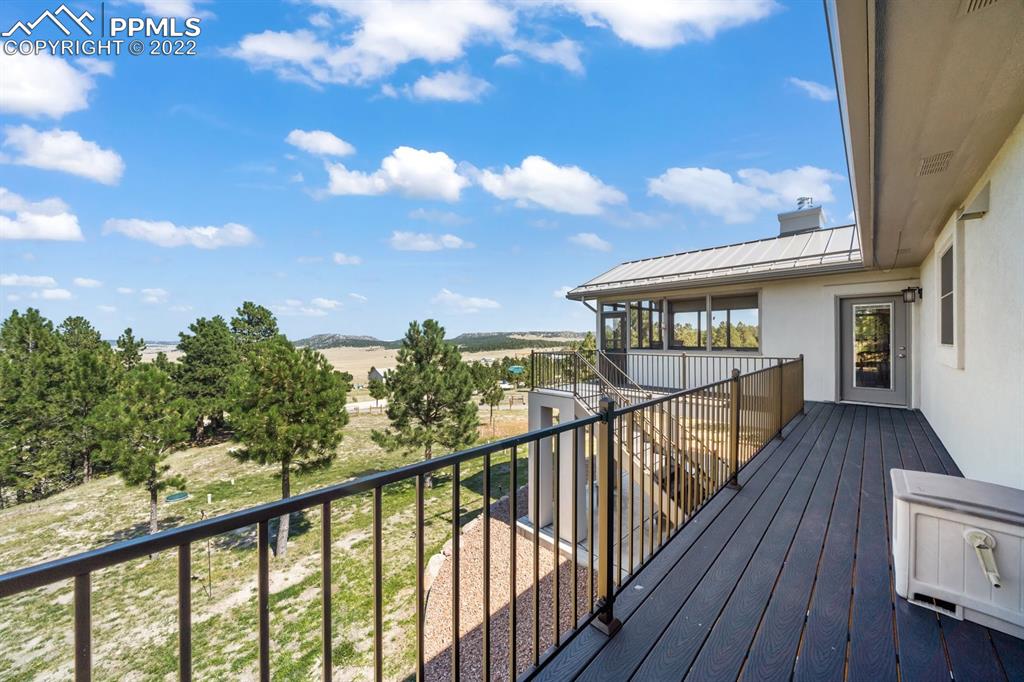 20765 Warriors Path Drive Peyton, CO 80831 - Photo 23 of 50 a view of a balcony with wooden floor and fence