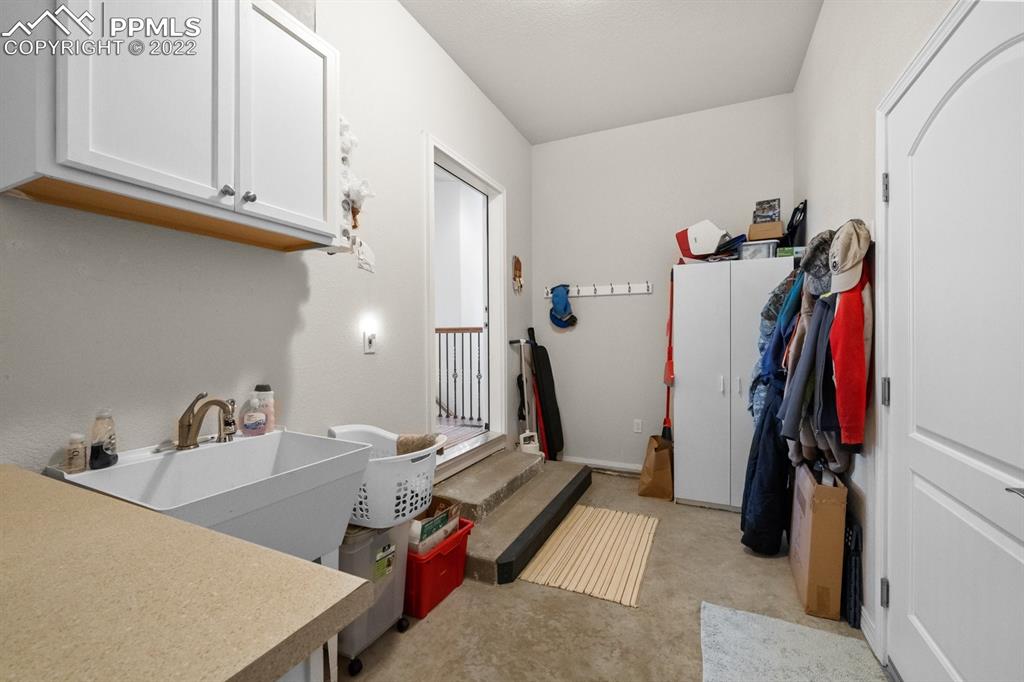 20765 Warriors Path Drive Peyton, CO 80831 - Photo 31 of 50 a view of walk in closet with clothes and shoes