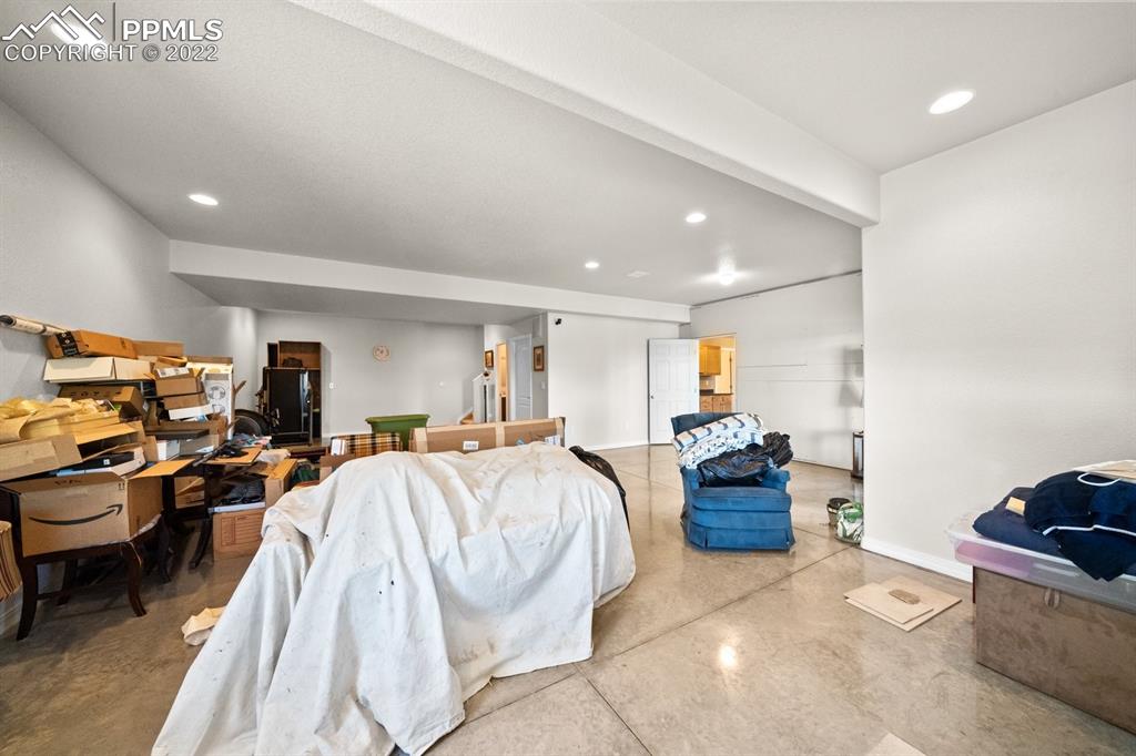 20765 Warriors Path Drive Peyton, CO 80831 - Photo 36 of 50 a bed room with furniture and a couch