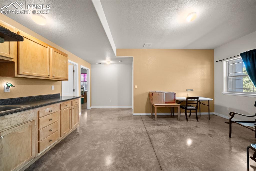 20765 Warriors Path Drive Peyton, CO 80831 - Photo 37 of 50 a open kitchen with cabinets table and chairs