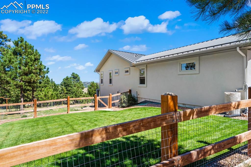 20765 Warriors Path Drive Peyton, CO 80831 - Photo 5 of 50 a front view of a house with a yard