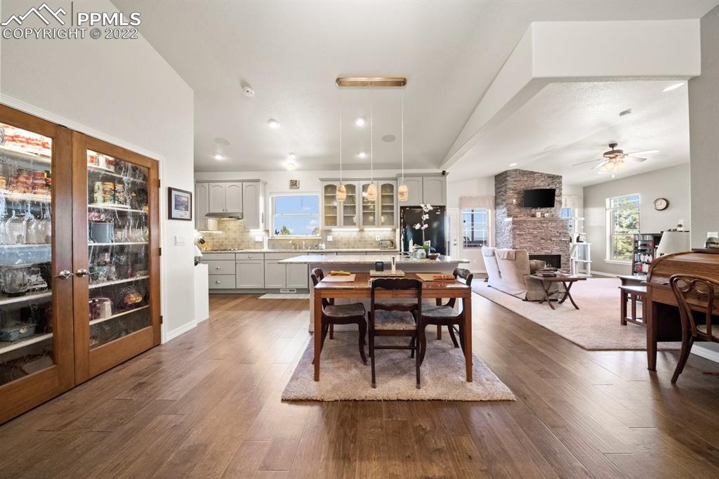 20765 Warriors Path Drive Peyton, CO 80831 - Photo 9 of 50 a living room with stainless steel appliances furniture wooden floor and a kitchen view