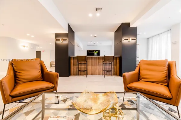 a living room with furniture and kitchen view