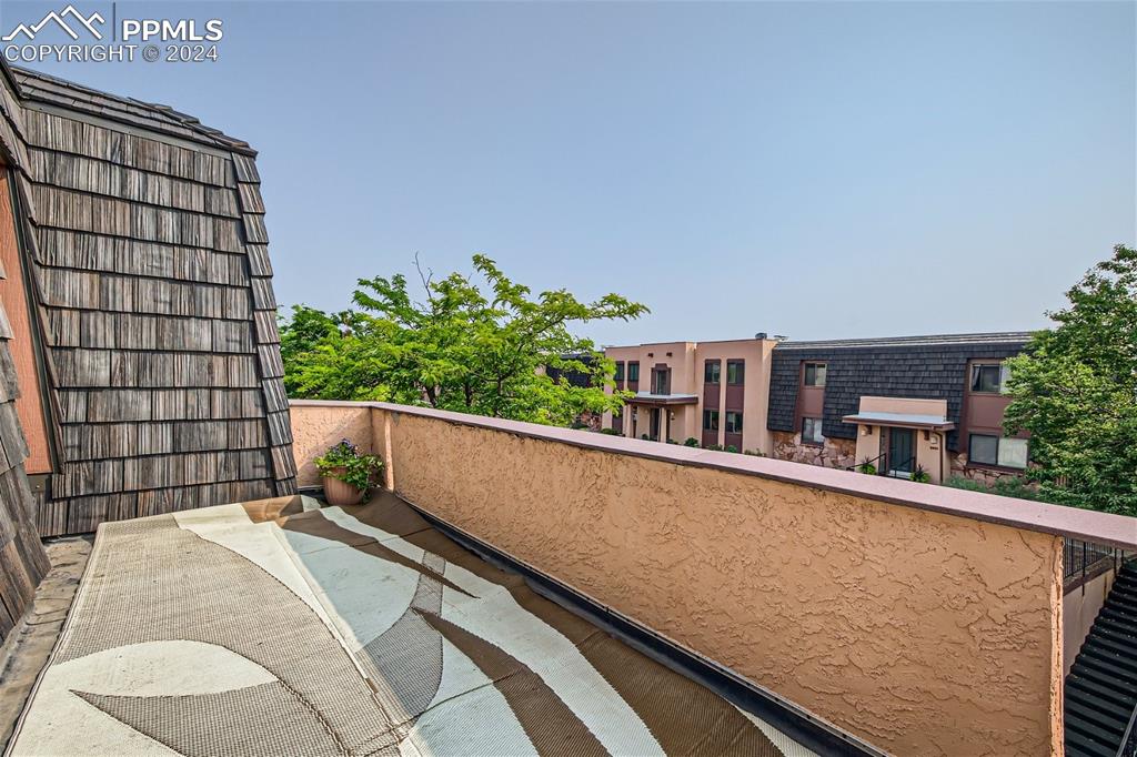 2913 Mesa Road, Unit A Colorado Springs, CO 80904 - Photo 11 of 15 a balcony with a potted plant on it