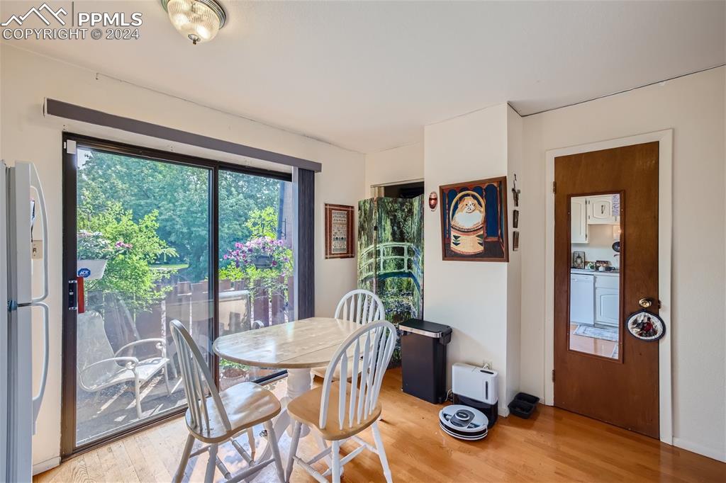 2913 Mesa Road, Unit A Colorado Springs, CO 80904 - Photo 5 of 15 a view of a dining room with furniture window and wooden floor