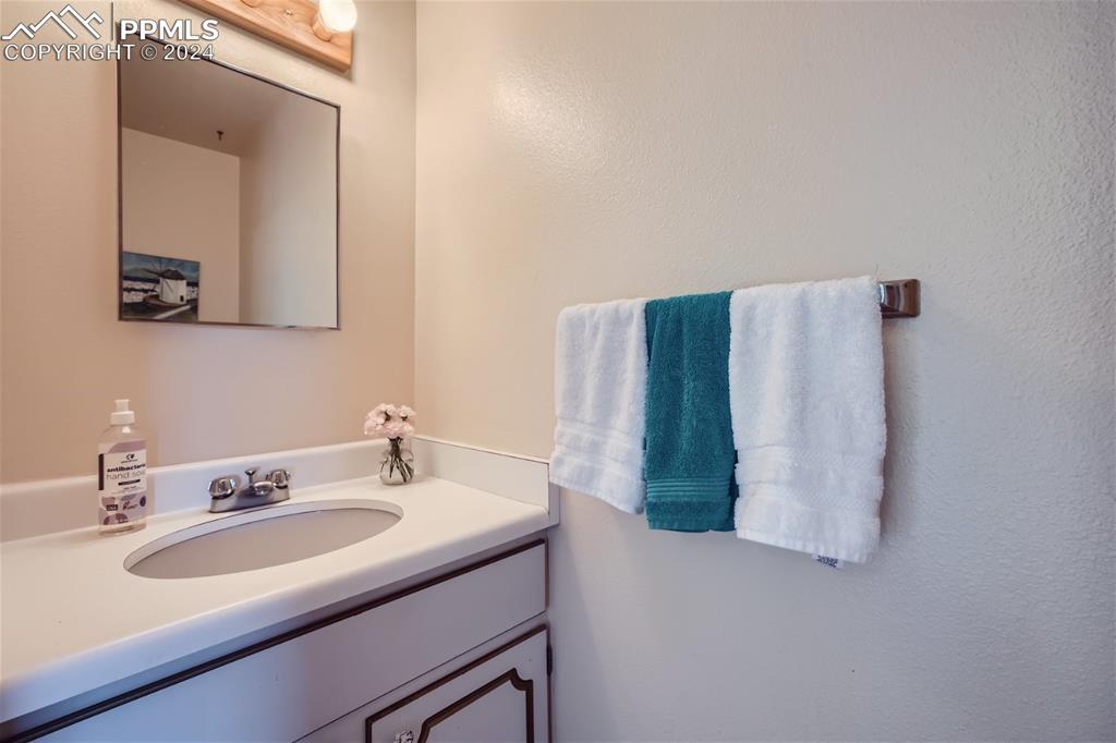 2913 Mesa Road, Unit A Colorado Springs, CO 80904 - Photo 7 of 15 a bathroom with a sink and a mirror