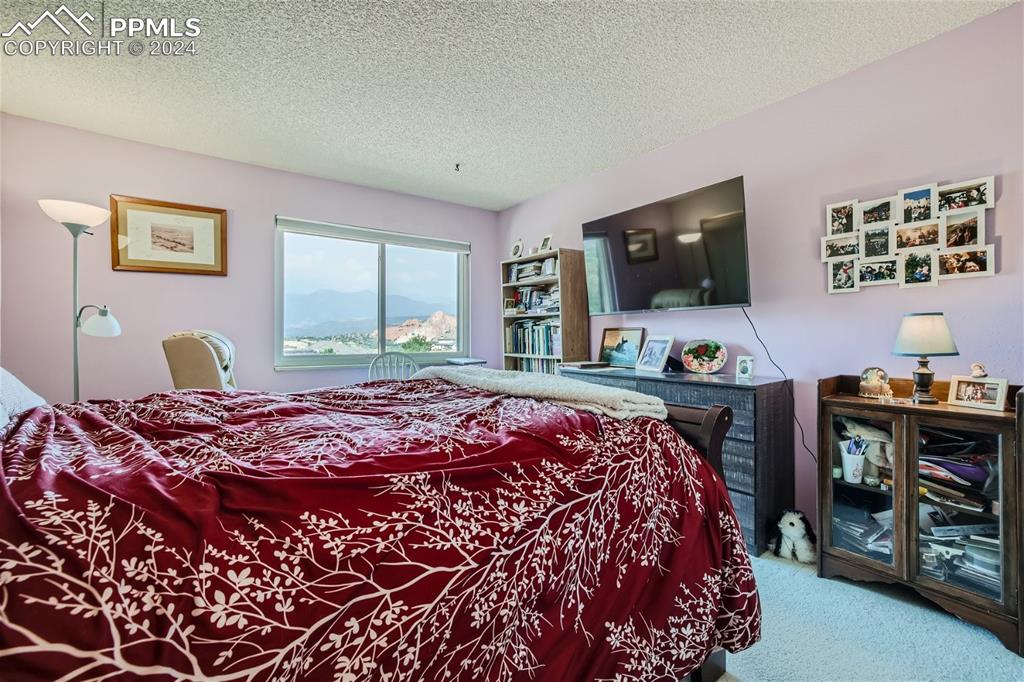 2913 Mesa Road, Unit A Colorado Springs, CO 80904 - Photo 8 of 15 a bedroom with a bed and a flat screen tv