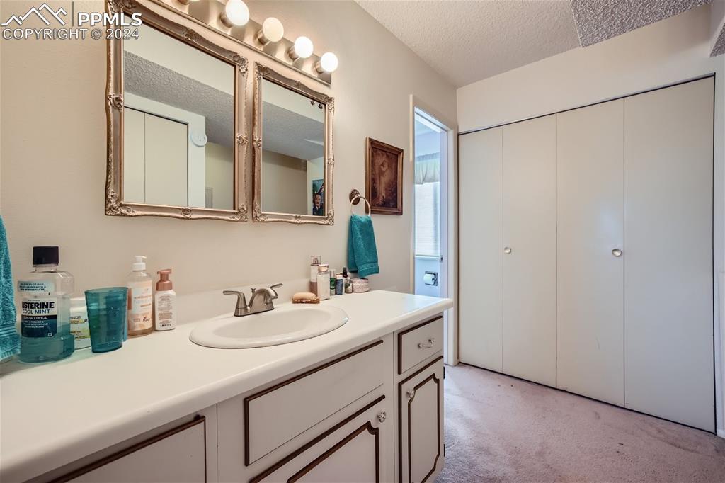 2913 Mesa Road, Unit A Colorado Springs, CO 80904 - Photo 10 of 15 a bathroom with a sink and a mirror
