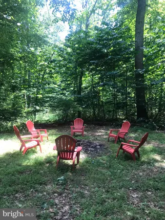 a backyard view with a seating space