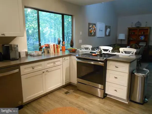 a kitchen with a stove sink and cabinets