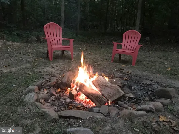 a view of a backyard with sitting area and fire pit